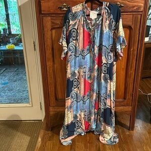 Johnny was maxi dress. Colors of blues pink tan yellow